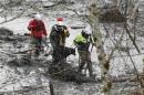 Rescue workers search for victims of a mudslide with a rescue dog in Oso, Washington