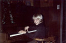 In this undated photo provided by Kim Cobain, a young Kurt Cobain plays piano in his childhood home in Aberdeen, Wash. Cobain's mother, Wendy O'Connor, is putting the 1.5-story Aberdeen bungalow _ which is assessed at less than $67,000 _ on the market for $500,000. But she'd also be happy entering into a partnership with anyone who wants to turn it into a museum. (AP Photo/Courtesy Kim Cobain)