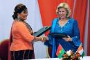 Ivory Coast's First Lady Dominique Ouattara (R) and her Burkina Faso counterpart Chantal Compaore shake hands on October 17, 2013 after signing cooperation agreements on fighting cross-border child trafficking, in Abidjan