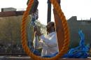An Iranian judiciary staff ties ropes prior to an execution in east Tehran on September 29, 2002