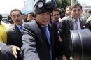 Ecuadorean President Rafael Correa wears a gas mask in Quito
