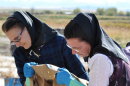 This undated image released by National Geographic Channels shows Hutterites Rita Hofer and Sarah Hofer pouring lye for soap in King Colony, Mont. "Meet the Hutterites," a National Geographic documentary series about a small religious colony in rural Montana, debuts Tuesday, May 29. (AP Photo/National Georgraphic, Ben Shank)