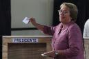 Chile's former President Michelle Bachelet casts her vote during Chile's general elections in Santiago, Chile, Sunday, Nov. 17, 2013. Bachelet is the front runner and conservative Evelyn Matthei is a distant second in Sunday's election for Chile's presidency. Seven other candidates could push the vote into a Dec. 15 runoff. (AP Photo/Luis Hidalgo)