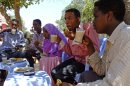 In this photo taken Saturday, March 31, 2012, customers drink coffee at an outdoor cafeteria in Mogadishu, Somalia. The seaside capital of Mogadishu is full of life for the first time in 20 years after African Union and Somali troops pushed Islamist militants out of the city last year. (AP Photo/Farah Abdi Warsameh)