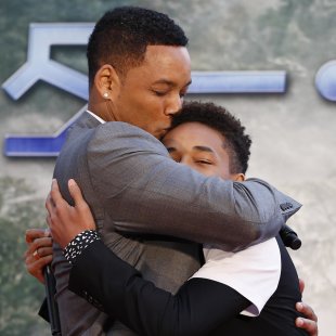U.S. actor Will Smith and his son Jaden Smith hug each other at a promotional event for their movie "After Earth" in Tokyo