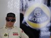 Lotus F1 Formula One driver Raikkonen stands in his team garage during the second practice session of the Japanese F1 Grand Prix at the Suzuka circuit
