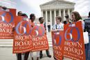 This photo taken May 13, 2014 shows National Education Association staff members from Washington joining students, parents and educators at a rally at the Supreme Court in Washington on the 60th anniversary Brown v. Board of Education decision that struck down 