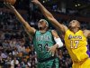 Boston Celtics forward Paul Pierce (34) drives to the basket past Los Angeles Lakers center Andrew Bynum (17) during the first quarter of an NBA basketball game in Boston, Thursday Feb. 9, 2012. (AP Photo/Charles Krupa)