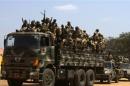 SPLA soldiers drive in a truck in Juba