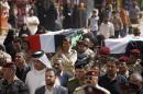 Mourners carry the flag-draped coffins of two Iraqi army officers during their funeral in the Shiite holy city of Najaf, 100 miles (160 kilometers) south of Baghdad, Iraq,Tuesday April 1, 2014. A series of attacks north of Baghdad killed several soldiers on Tuesday as Iraq's election campaign officially kicked off ahead of the April 30 nationwide vote. (AP Photo/Jaber al-Helo)