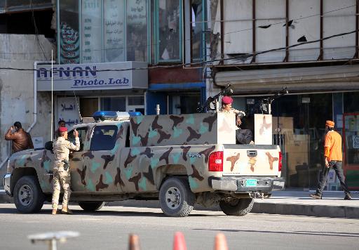 Iraqi soldiers in a military vehicle patrol a street in central Baghdad, on December 1, 2013