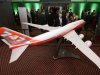 Delegates of the 68th IATA annual general meeting look at a model of new Boeing 747 aircraft in Beijing