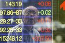 A man is reflected on the electronic board of a securities firm in Tokyo, Monday, June 10, 2013. Asian markets rose Monday after U.S. jobs data helped allay concern the Fed might wind down its stimulus and Japan's prime minister promised new tax cuts. Tokyo's Nikkei 225, the regional heavyweight, jumped 2.8 percent to 13,245 while Hong Kong's Hang Seng Index added just under 0.1 percent to 21,589.0. (AP Photo/Koji Sasahara)