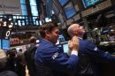 A trader applauds while working on the floor of the New York Stock Exchange on February 21
