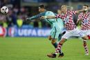 Portugal's Cristiano Ronaldo, left, and Croatia's Domagoj Vida go for the ball during the Euro 2016 round of 16 soccer match between Croatia and Portugal at the Bollaert stadium in Lens, France, Saturday, June 25, 2016. (AP Photo/Frank Augstein)