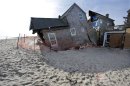 FILE - In this Jan. 3, 2013 photo, a beach front home that was severely damaged by Superstorm Sandy rests in the sand in Bay Head, N.J. (AP Photo/Mel Evans)