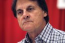 FILE - In a Sunday, Jan. 15, 2012 file photo, former St. Louis Cardinals manager Tony La Russa pauses while signing autographs for fans during the baseball team's annual Winter Warmup, in St. Louis. William Morrow announced Monday, March 19, 2012 that a La Russa memoir, 