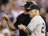 New York Yankees manager Joe Girardi (28) talks with home plate umpire Chad Fairchild about a play review during the third inning of a baseball game against the Kansas City Royals in Kansas City, Mo., Wednesday, Aug. 17, 2011. (AP Photo/Orlin Wagner)
