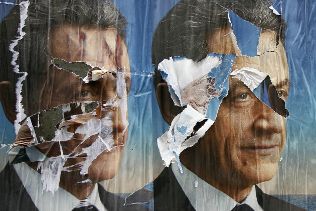 Torn election posters of French President Nicolas Sarkozy in Paris May 6