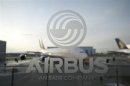 An A380 aircraft is seen through a window with an Airbus logo during the EADS / Airbus 'New Year Press Conference' in Hamburg January 17, 2012. REUTERS/Morris Mac Matzen