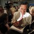 Republican presidential candidate former Massachusetts Gov. Mitt Romney signs an autograph on a paperback book of his new jobs and plan for the economy after a town hall meeting Wednesday, Sept. 14, 2011, in Sun Lakes, Ariz. (AP Photo/Ross D. Franklin)