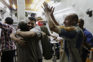 Egyptians celebrate at a tea house at Defense Minister …