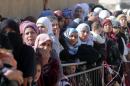 Syrian families, who fled recent violence in the mountainous Qalamoun region, queue to be registered by the UNHCR on November 19, 2013 in Arsal