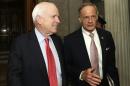 Senators McCain and Carper talk outside of Senate chamber after budget vote on Capitol Hill in Washington