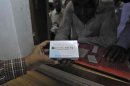 Man buys cancer drug Glivec for a relative who is suffering from cancer at a pharmacy in a government-run hospital in Ahmedabad