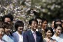 Japan's PM Abe and his wife Akie exchange smiles with show-business celebrities during a cherry blossom viewing party in Tokyo