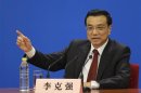 China's newly-elected Premier Li answers questions during a news conference after the closing session of the NPC in Beijing