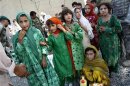 Girls wait to receive humanitarian aid distributed by the U.S. army at the village of Doment, in Afghanistan's Kunar province