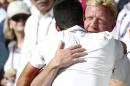 Novak Djokovic of Serbia celebrates with his coach Boris Becker, right, in the players box after defeating Roger Federer of Switzerland in the men's singles final at the All England Lawn Tennis Championships in Wimbledon, London, Sunday July 6, 2014. (AP Photo/Pavel Golovkin)