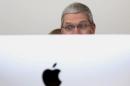 Apple CEO Tim Cook looks at a new IMac after presentation at Apple headquarters in Cupertino