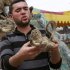 In this photo taken Wednesday, April 18, 2012 Palestinian zoo owner Mohammed Awaida holds a mummified monkey at the Khan Younis zoo, southern Gaza Strip. There is an afterlife for animals at Gaza's Khan Younis zoo. Animals who die in the dilapidated park come to life again as stuffed creatures. But because the taxidermy in the impoverished Palestinian territory relies on techniques available on the Internet, the unusual wildlife experience of petting a lion, tiger or crocodile can be a grim one.(AP Photo/Adel Hana)