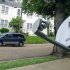 In this May 11, 2009 photo, a mini-van passes a DirecTV satellite dish in a residential area adjoining downtown Jackson, Miss. Tribune Broadcasting says there's been no settlement with DirecTV Inc. in their contract negotiations, which means DirecTV subscribers in 19 U.S. markets will lose access to certain programming, Saturday, March 31, 2012.  (AP Photo/Rogelio V. Solis)
