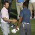 In this photo made May 12, 2013, Sergio Garcia, of Spain, left, shakes hands with Tiger Woods at the end of the third round of The Players championship golf tournament at TPC Sawgrass in Ponte Vedra Beach, Fla. Garcia apologized to Woods on Wednesday, May 22, 3013, for saying he would have "fried chicken" at dinner with his rival, a comment that Woods described as hurtful and inappropriate.  (AP Photo/Gerald Herbert)