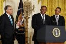 U.S. President Barack Obama listens to Charlotte Mayor Anthony Foxx speak in Washington