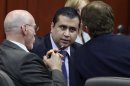 FILE - In this July 13, 2013, file photo, George Zimmerman, center, talks to his attorneys Don West, left, and Mark O'Mara during jury deliberations in his trial in Seminole circuit court in Sanford, Fla. Almost as soon as Zimmerman was pronounced "not guilty, the cry of protestors went up, that the U.S. government must get "justice for Trayvon," the unarmed black teenager Trayvon Martin, killed by Zimmerman. Attorney General Eric Holder, the first black man to lead the nation's law enforcement, says the Justice Department is investigating. But an investigation does not mean a case will move forward; these investigations can take months, even years, and are hard to prosecute. (AP Photo/Orlando Sentinel, Gary W. Green, Pool)