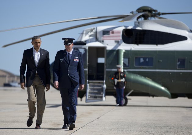 President Barack Obama walks with Col. Greg Urtso to board Air Force One, Sunday, May 26, 2013, at Andrews Air Force Base, Md., en route to Moore, Okla., to visit with families and first responders in the wake of the tornadoes and severe weather that devastated the area. (AP Photo/Carolyn Kaster)