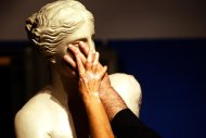 Visually-impaired Athens Paralympic officials feel a statue of the Venus of Milo at the Tactual Museum in Athens in 2004. A 29-year-old jailed for robbery in Greece was found to have cheated the cash-strapped state out of disability benefits worth thousands of euros for years, the semi-state Athens News Agency said Thursday. (AFP Photo/Fayez Nureldine)