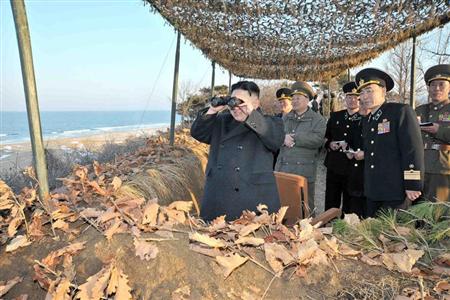 North Korean leader Kim Jong-Un (L) watches soldiers of the Korean People's Army (KPA) taking part in the landing and anti-landing drills of KPA Large Combined Units 324 and 287 and KPA Navy Combined Unit 597, in the eastern sector of the front and the east coastal area on March 25, 2013, in this picture released by the North's KCNA news agency in Pyongyang March 26, 2013. REUTERS/KCNA