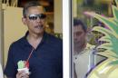 President Barack Obama holds his shave ice as he exits Island Snow to greet people waiting outside, Tuesday, Dec. 31, 2013. The first family is in Hawaii for their annual holiday vacation. (AP Photo/Carolyn Kaster)
