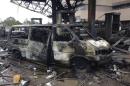 The charred wreckage of a minivan is seen at a gas station that exploded overnight killing around 90 people in Accra