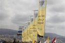 Banners erected by Hezbollah depicting Pope Benedict XVI as well as Lebanese and Vatican flags decorate a main airport road in Beirut, September 13, 2012, in preparation for the pope's arrival tomorrow.