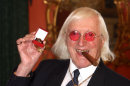 FILE - This is a March 25, 2008 file photo of Sir Jimmy Savile, who for decades was a fixture on British television. A year after he died, aged 84 and honored as Sir Jimmy, several women have come forward to claim he was also a sexual predator and serial abuser of underage girls. The child abuse scandal that has enveloped the BBC, one of Britain's most respected news organizations, is now hitting one of America's, as the incoming president of The New York Times is on the defensive about his final days as head of the BBC. Mark Thompson was in charge of the BBC in late 2011 when the broadcaster shelved what would have been a bombshell investigation alleging that the late Savile was a serial sex offender. (AP Photo/ Lewis Whyld/PA, File)