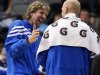 Dallas Mavericks' Dirk Nowitzki, left, of Germany, laughs as he talks with Chris Kaman, right, during the second half of a preseason NBA basketball game against the Phoenix Suns, Wednesday, Oct. 17, 2012, in Dallas. Nowitzki did not play in the 100-94 loss to the Suns. (AP Photo/Tony Gutierrez)