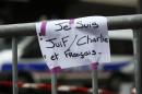 A sign reading "I am Jewish, Charlie and French" (Je suis Juif, Charle et Francais) is seen near a kosher grocery store in Porte de Vincennes, eastern Paris, on January 10, 2015 a day after four people were killed at the Jewish supermarket