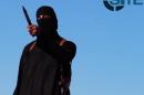 An image grab taken from a video released by the Islamic State and identified by private terrorism monitor SITE on September 13, 2014 purportedly shows a masked militant before beheading British aid worker David Haines