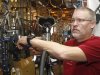 Steve Schlegel, owner of Schlegel Bicycles, answers a question while working on a bicycle in the shop's pro shop, in Oklahoma City, Thursday, Jan. 26, 2012. (AP Photo/Sue Ogrocki)